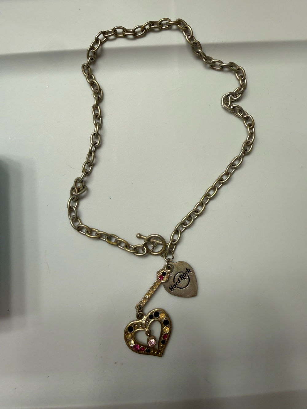 Hard Rock Cafe Gold-Tone Guitar Pick Charm Necklace with Pink Accent